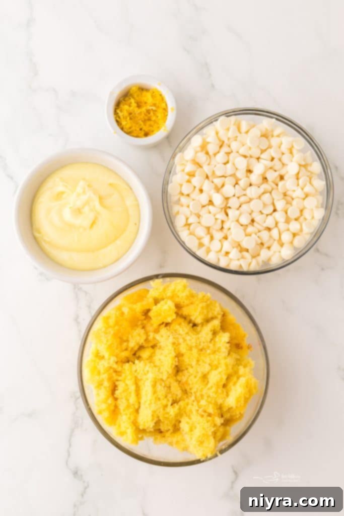 Several homemade lemon truffles arranged artfully on a serving tray, garnished with fresh lemon zest.