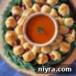 Dorothy's Pigs in a Blanket Wreath on a wood stump serving platter