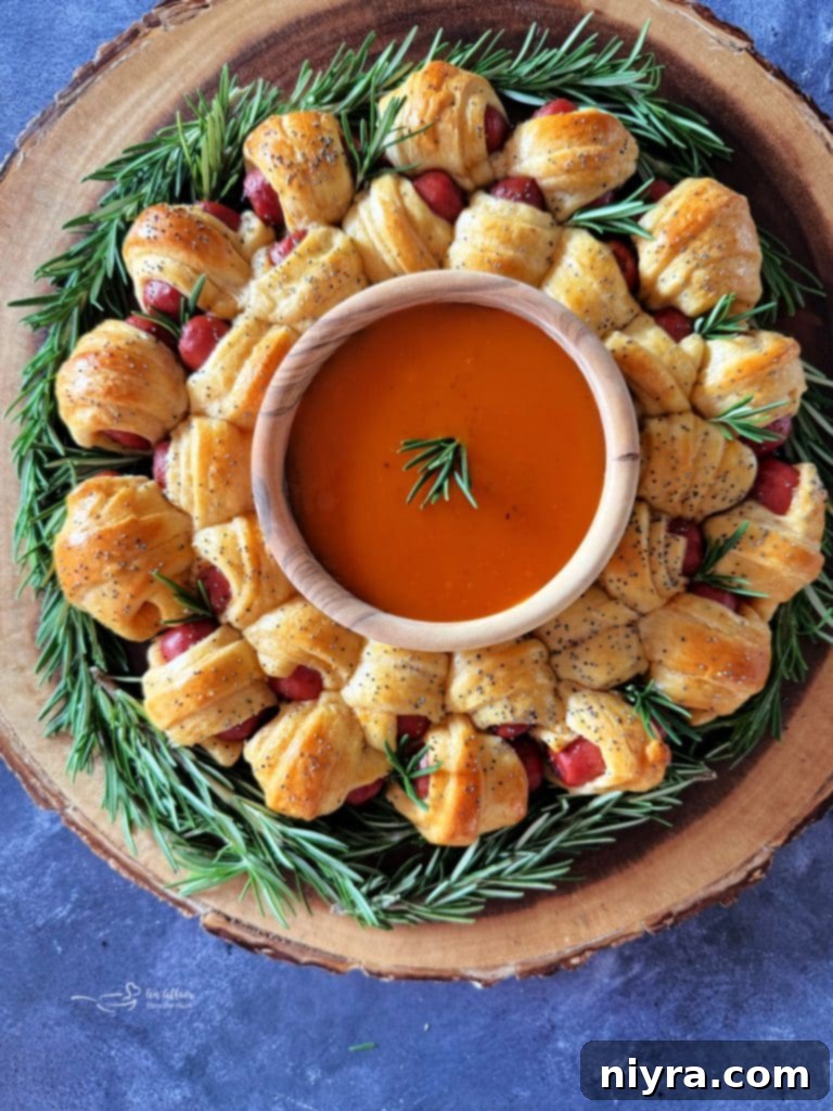 A beautifully baked Pigs in a Blanket Wreath, glistening with egg wash and poppy seeds, presented on a rustic wooden board.