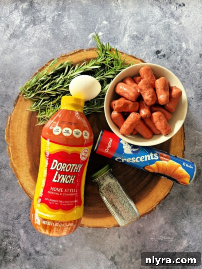 Appetizer Pigs in a Blanket Wreath on a white plate, showcasing the golden-brown crescent rolls and poppy seeds.