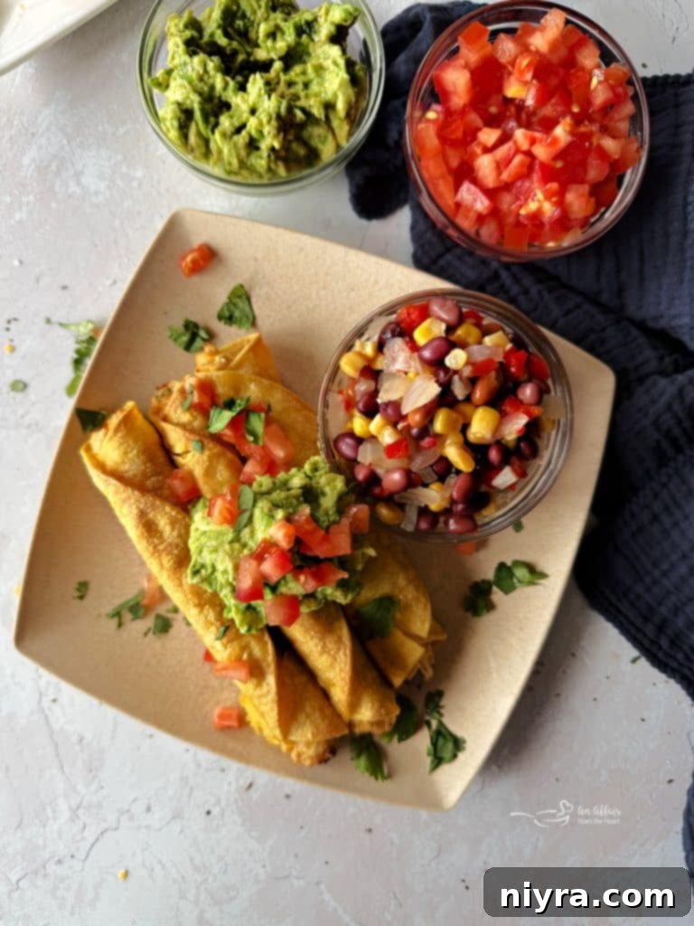 Another view of the delicious Chicken and Cowboy Caviar Taquitos on a plate