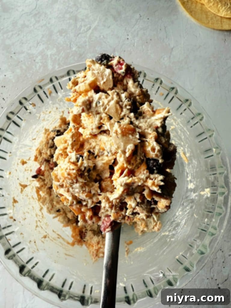 Mixing the creamy chicken and Cowboy Caviar filling in a bowl