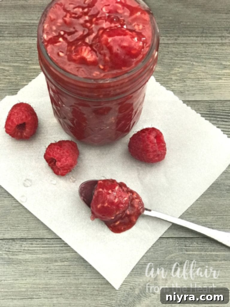 Vibrant homemade raspberry sauce in a glass bowl