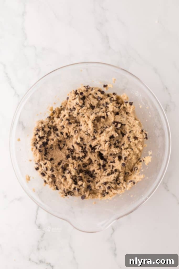 Bite-Sized Chocolate Chip Delights 7 Mini chocolate chip cookie dough balls on a baking sheet