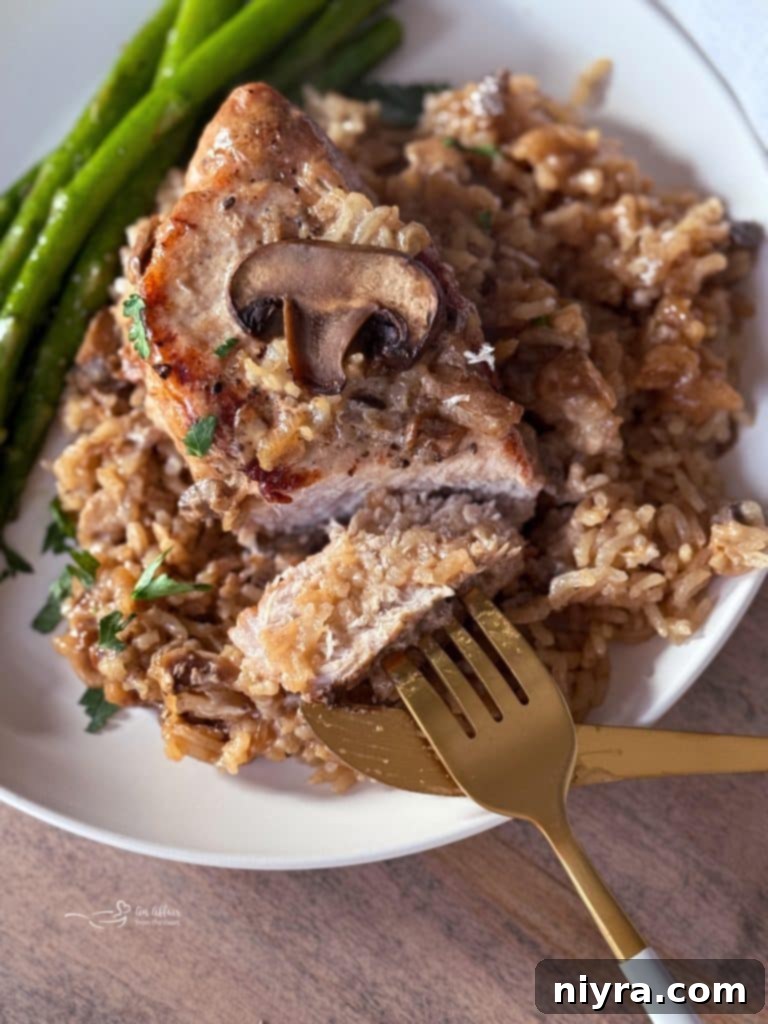 Close-up of baked No Peek Pork Chops and Rice with mushrooms.