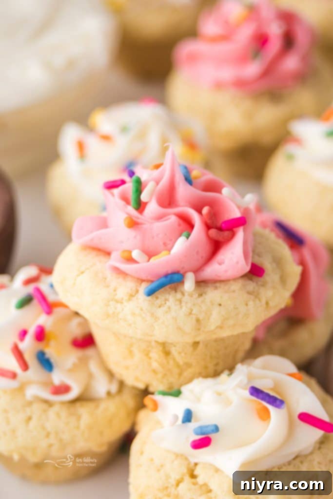 Frosted Sugar Cookie Delights 2 A close-up of a sugar cookie cup with pink frosting and sprinkles.
