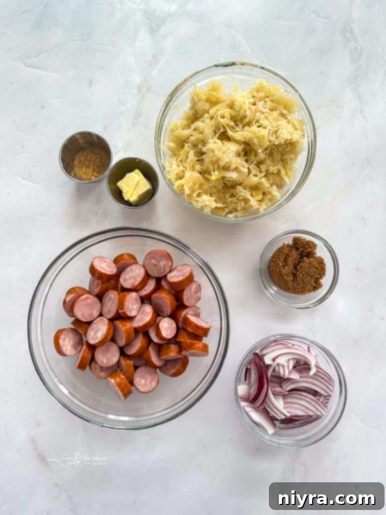 Cooked kielbasa and sauerkraut mixture in a cast-iron skillet