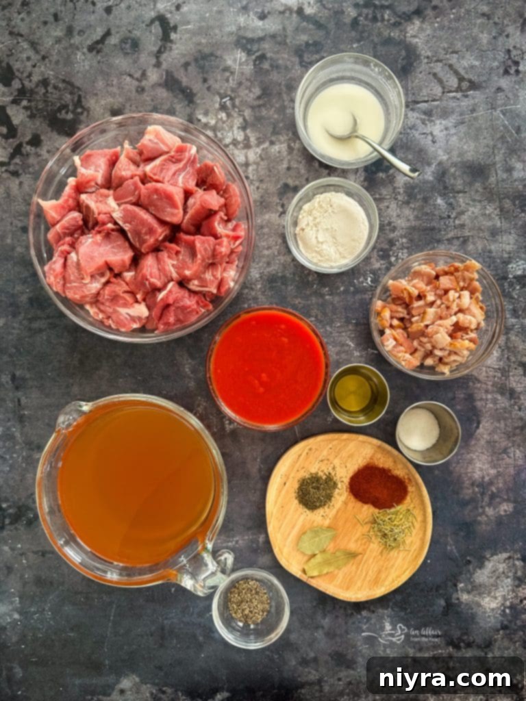 A serving of pork stew in a bowl, garnished with fresh herbs.