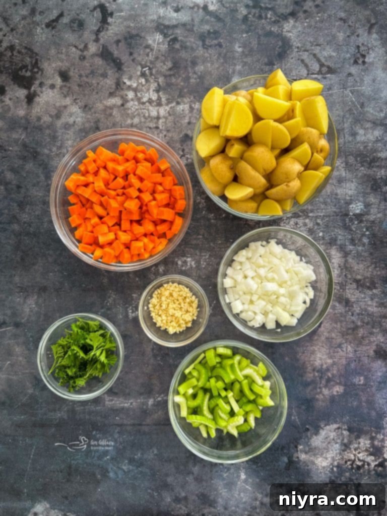 Close-up of fresh vegetables for pork stew: carrots, celery, onion, potatoes.