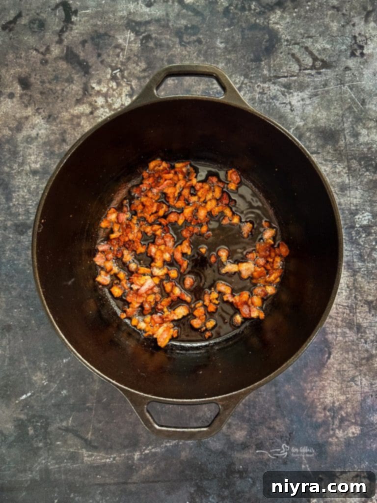 Searing bacon in a Dutch oven for pork stew.