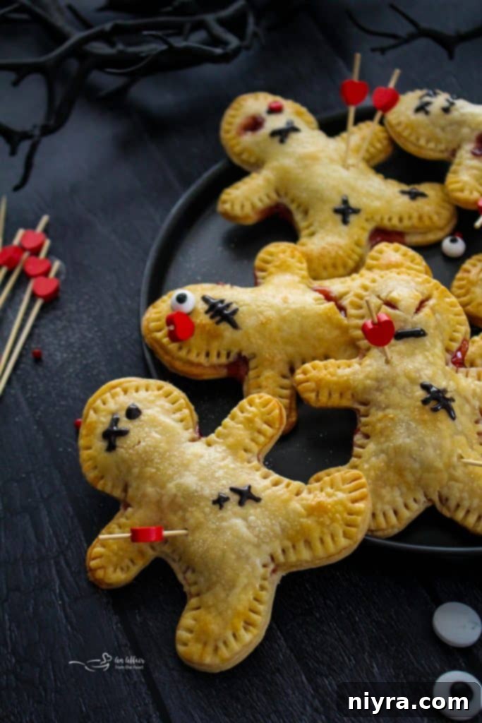 Voodoo Doll Hand Pie with cherry filling oozing out