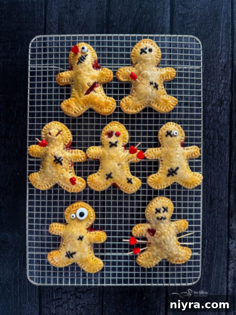 Baked Voodoo Doll Hand Pies cooling on a wire rack