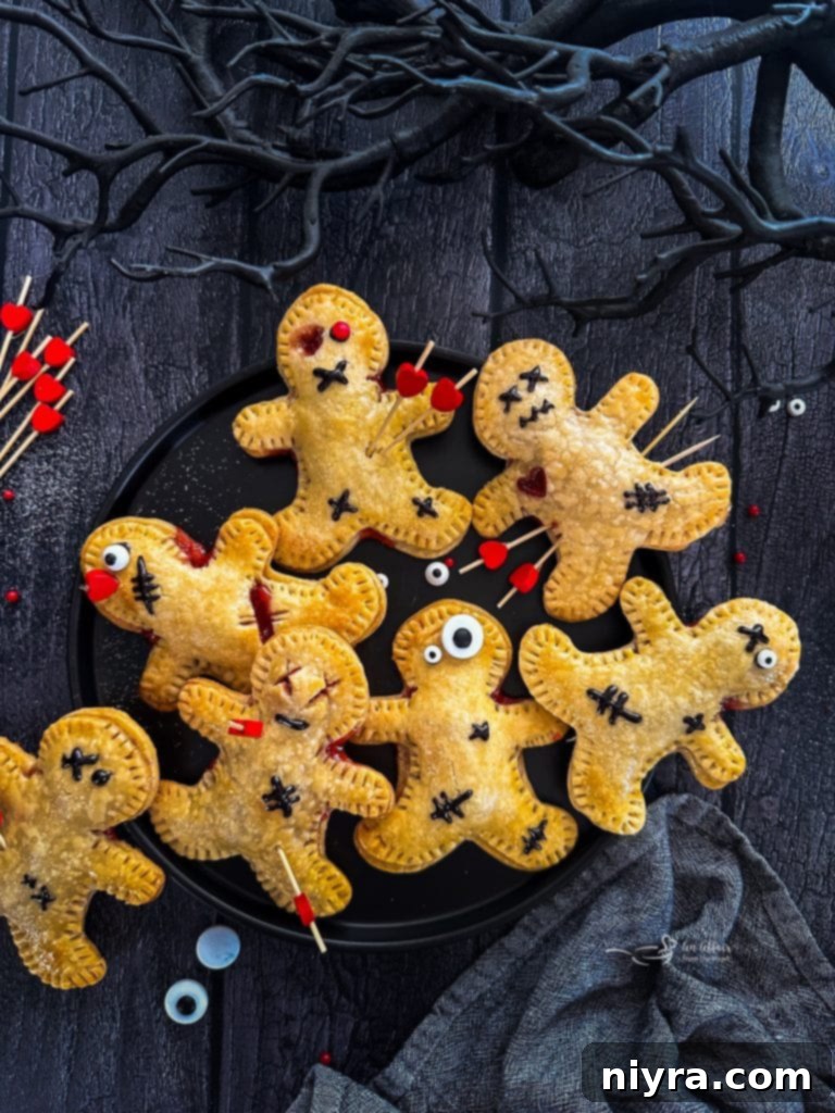 Close-up of a Voodoo Doll Hand Pie with toothpick pins and stitched eyes