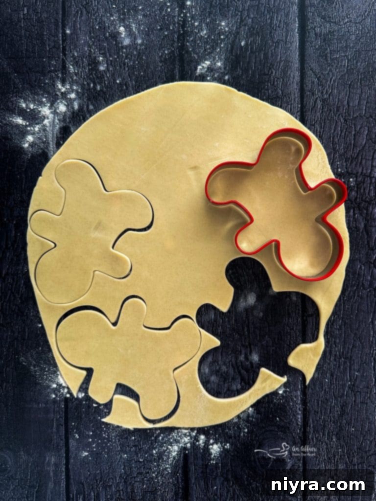 Rolled out pie crust with gingerbread man cutouts