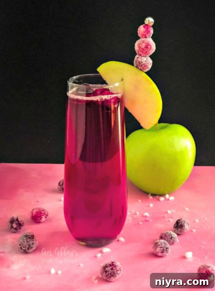 A vibrant CranApple Fizz Cocktail, perfectly garnished with fresh cranberries, in a tall glass, set against a festive, cozy background.
