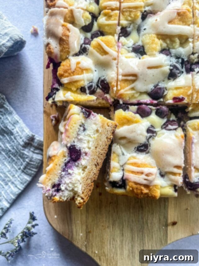 Zesty Key Lime Pie Bars 15 A close-up of a Lemon Blueberry Crumb Bar, highlighting the crumbly topping and fruity filling.