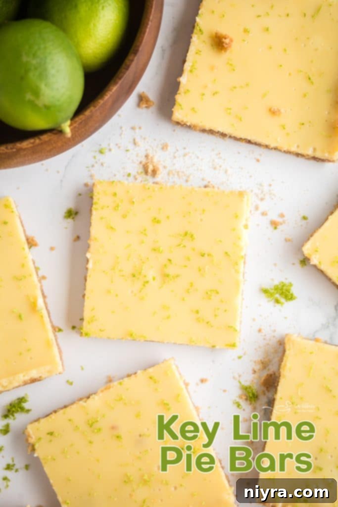 Zesty Key Lime Pie Bars 16 A beautifully presented Key Lime Pie Bar with lime zest on a white plate, ready to be served.