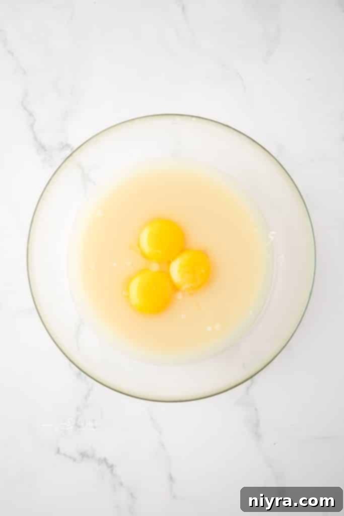 Zesty Key Lime Pie Bars 9 Whisking together eggs, sweetened condensed milk, and key lime juice for the pie filling.