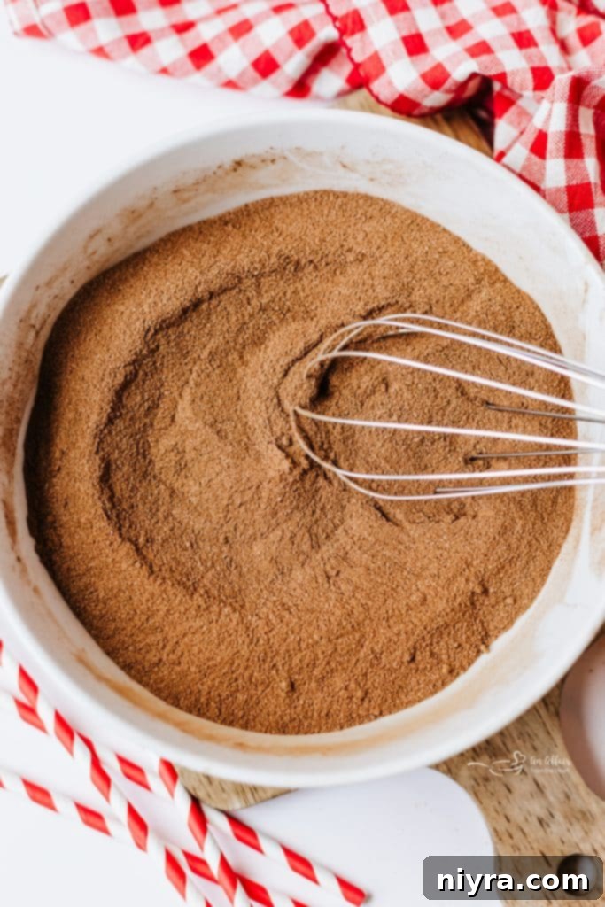 Homemade Copycat Nesquik Recipe 6 Close-up of powdered ingredients being sifted for homemade Nesquik, ensuring a smooth texture.