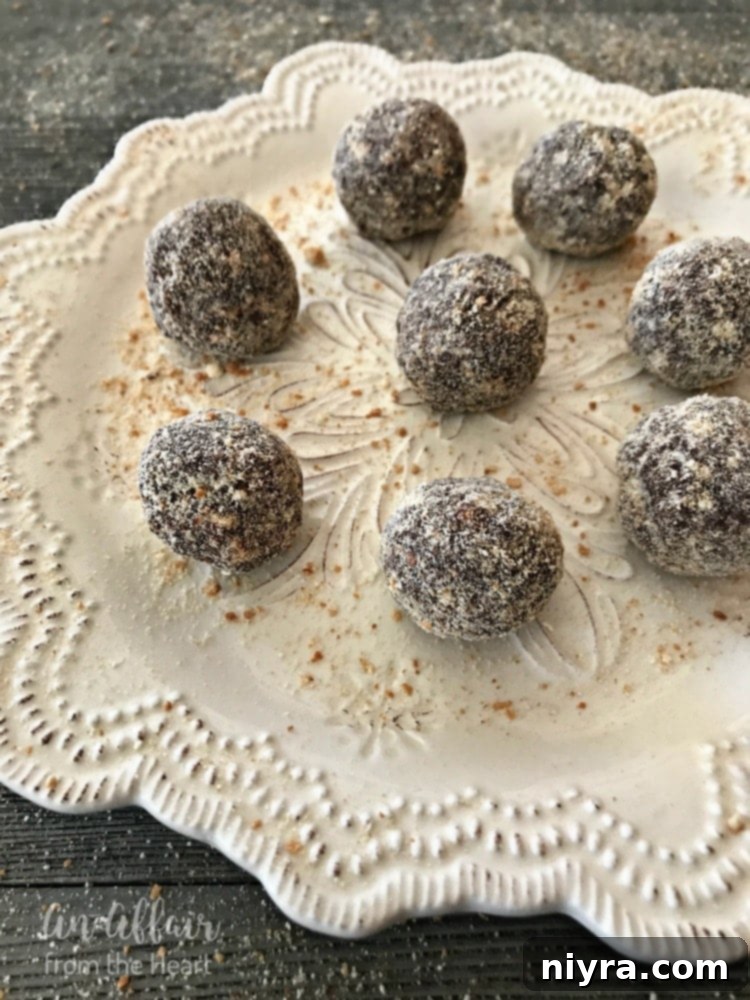 Beautifully rolled Mocha Rum Balls coated in crushed vanilla wafers, displayed on a plate.