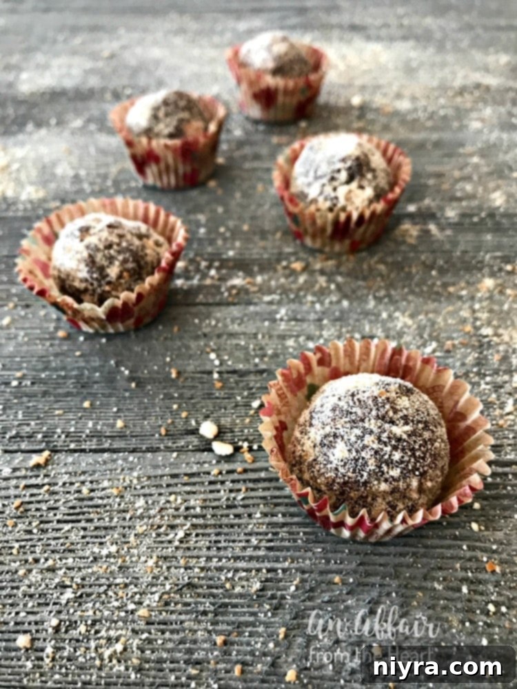 Mocha Rum Balls neatly placed in decorative paper liners, ready for gifting or serving at a cookie exchange.