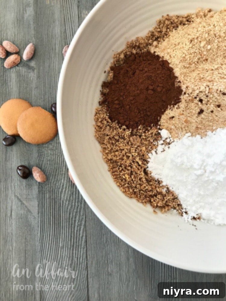 Ingredients for Mocha Rum Balls, including vanilla wafers and almonds, in a food processor.