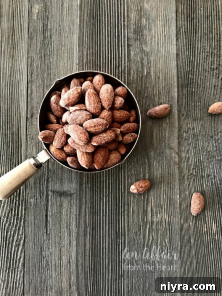 Key ingredients for Mocha Rum Balls laid out on a surface: vanilla wafers, almonds, cocoa powder, espresso beans, powdered sugar.