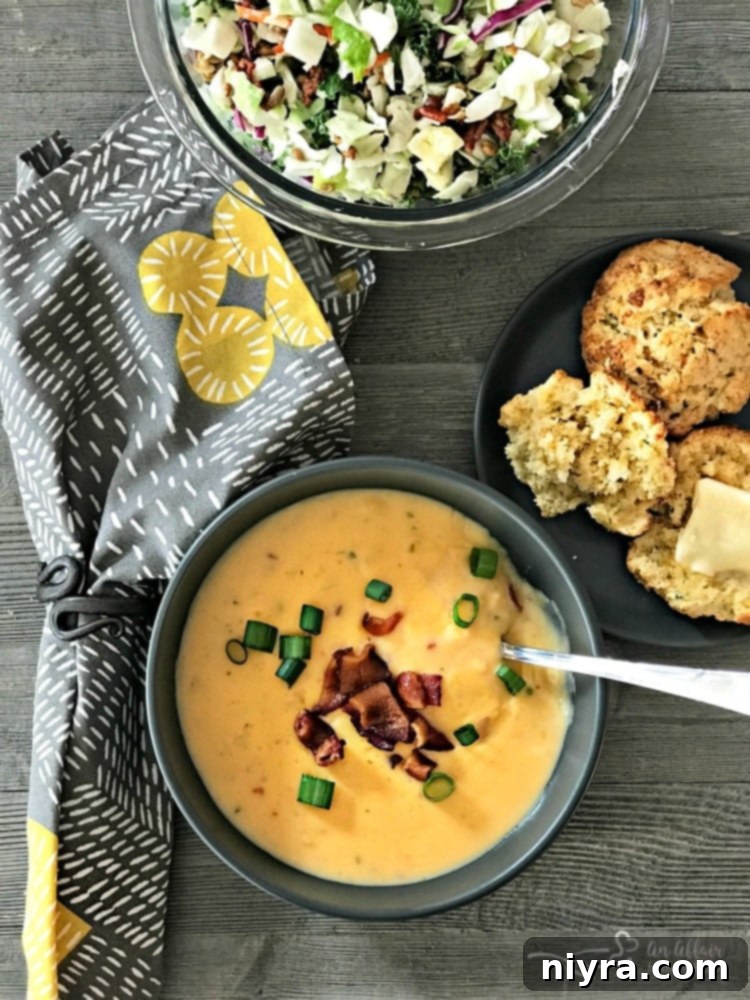 A full meal featuring creamy potato soup, a fresh side salad, and Cheesy Cornbread Drop Biscuits