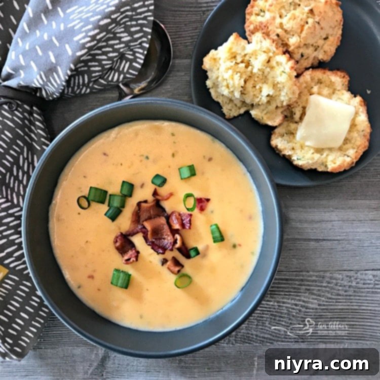 Cheesy Cornbread Drop Biscuits served in a bowl with soup, garnished with green onions and bacon
