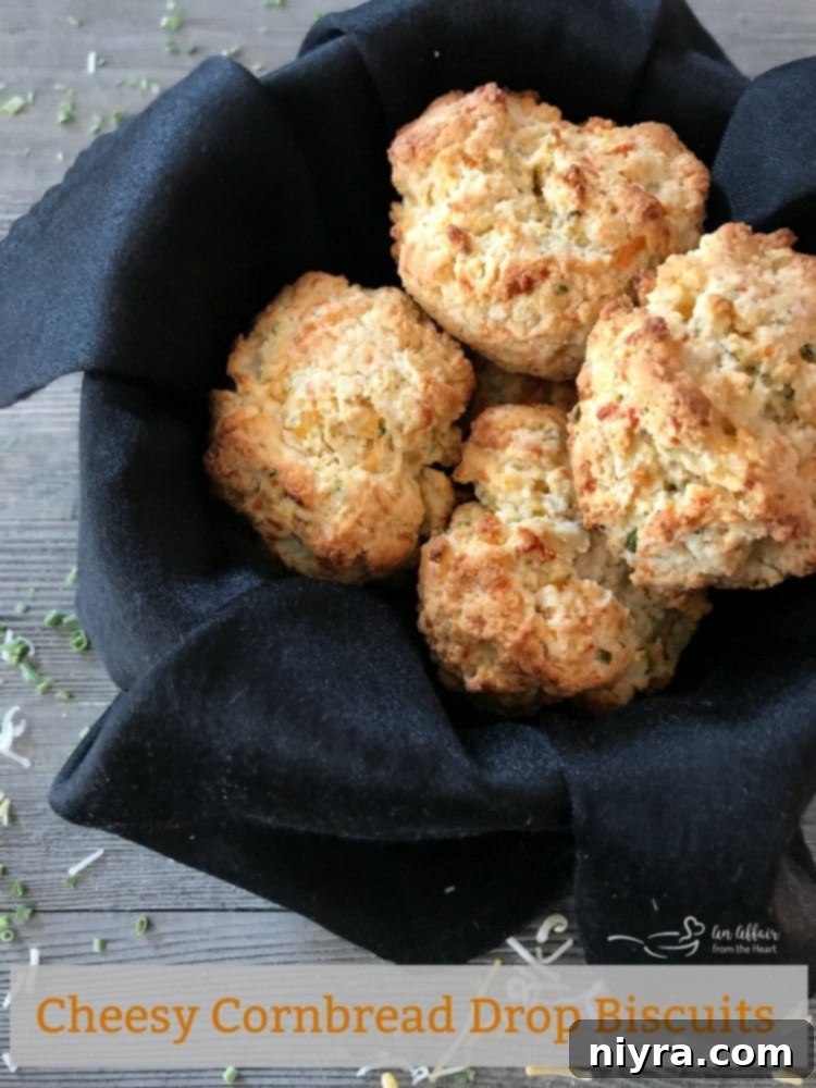 Hero shot of a stack of golden Cheesy Cornbread Drop Biscuits, perfectly baked