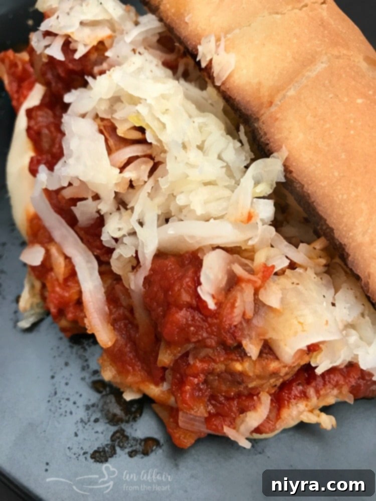A fully assembled Instant Pot Twisted Meatball Sub, loaded with meatballs, sauce, cheese, and sauerkraut.
