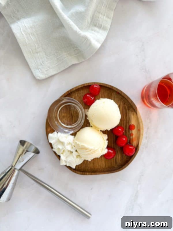 Pink Velvet Dream 4 Close-up of a Pink Squirrel cocktail with a cherry garnish.