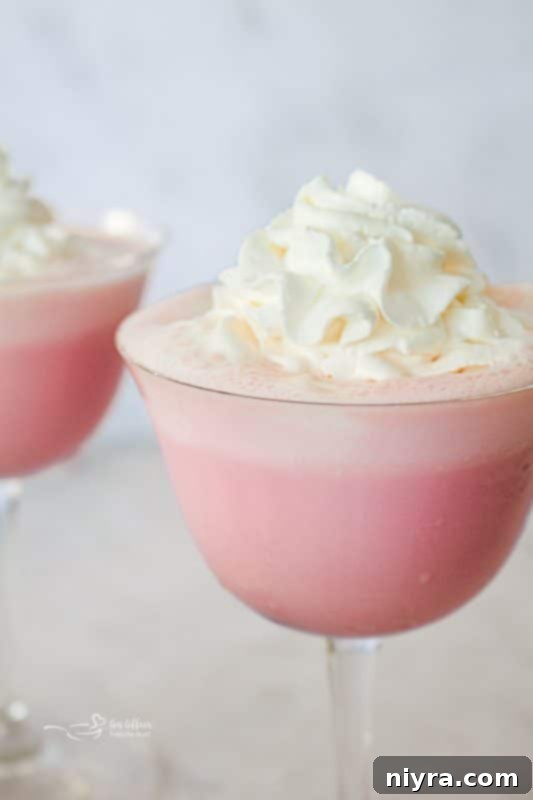 Pink Velvet Dream 10 Pink Squirrel cocktail poured into a glass.