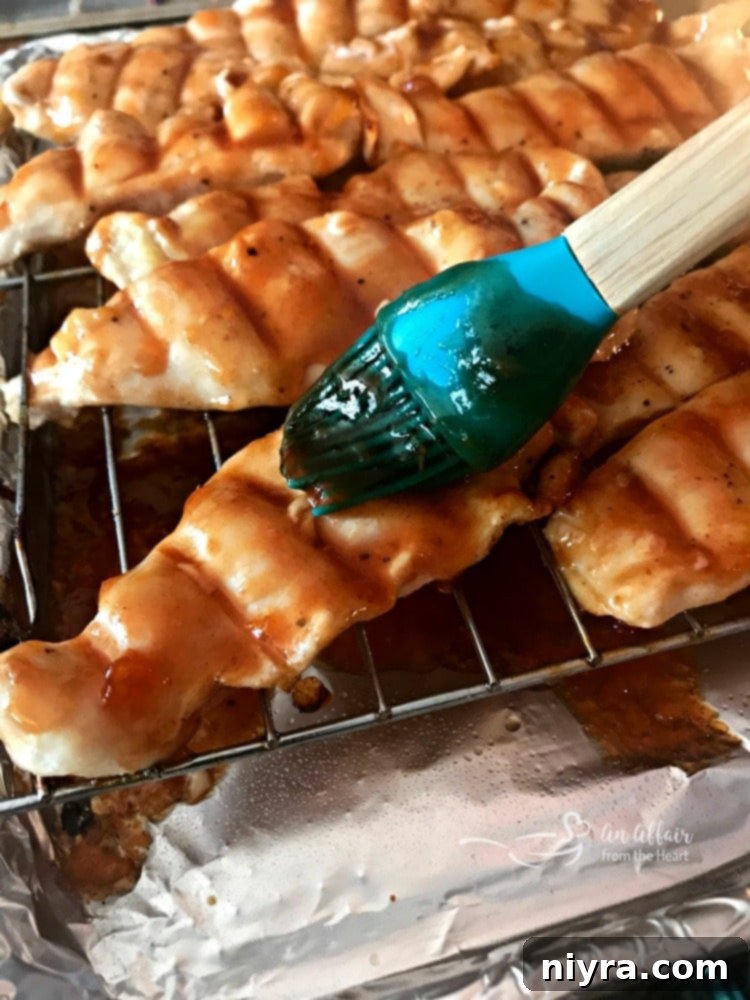 Apricot BBQ Glazed Chicken being basted in the oven.
