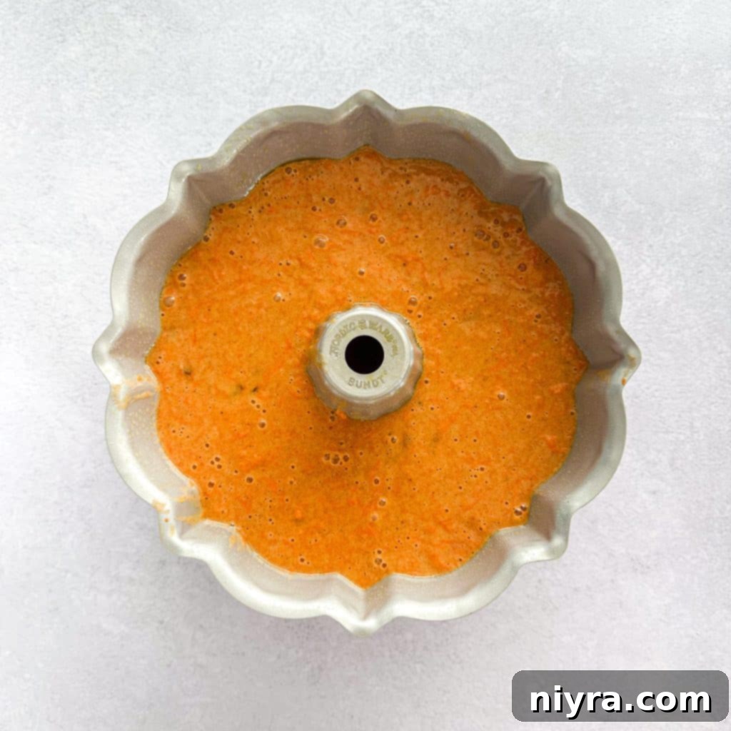 Finely grated carrots and golden raisins folded into carrot cake batter