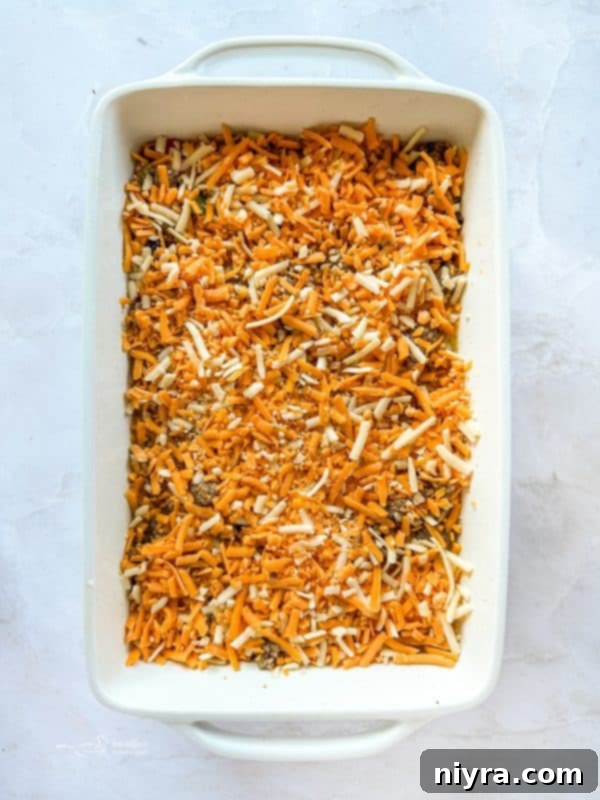 Golden Sausage Crescent Roll Bake 14 Sprinkling cheese over casserole