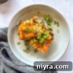 Golden Sausage Crescent Roll Bake 24 Overhead of Slices of Sausage Crescent Breakfast Bake on a white plate