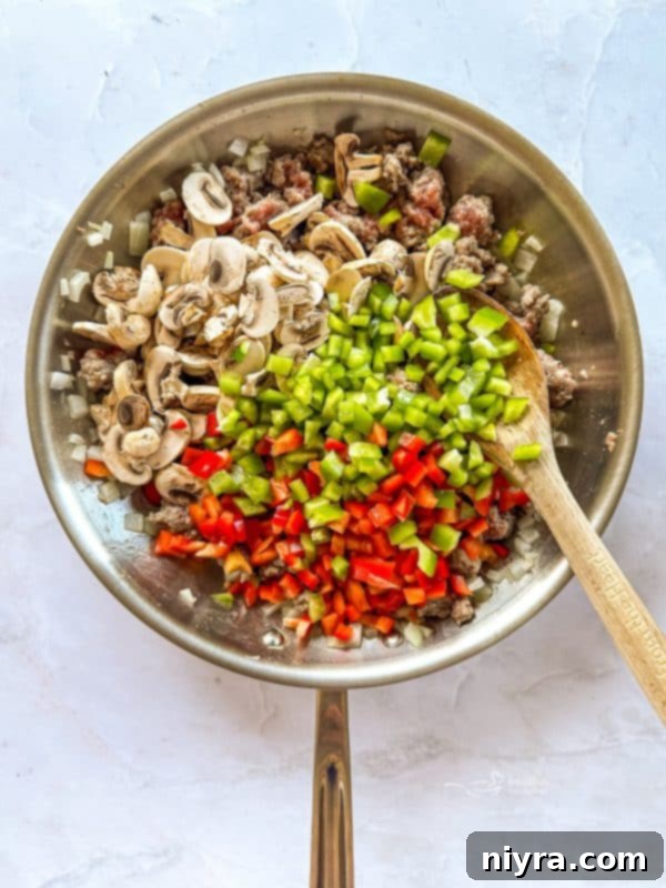 Golden Sausage Crescent Roll Bake 9 Adding mushrooms and peppers to sausage