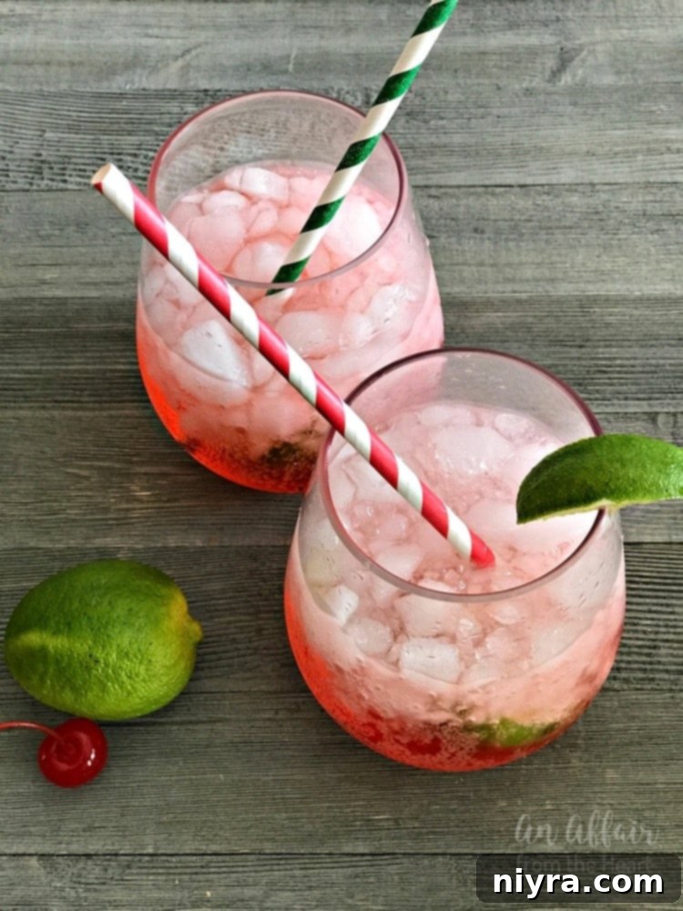 Homemade Copycat Sonic Cherry Limeade in a glass with crushed ice and cherries.