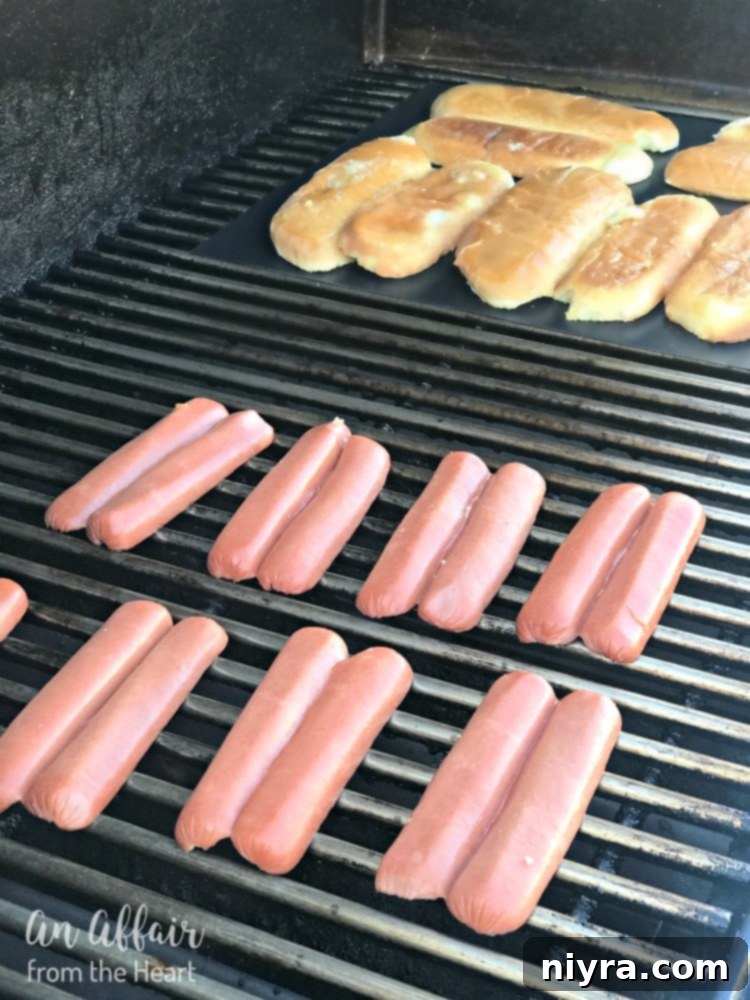 Ball Park Beef Franks sliced lengthwise and opened, resting beside prepared buns on a grilling mat, all ready for the barbecue.