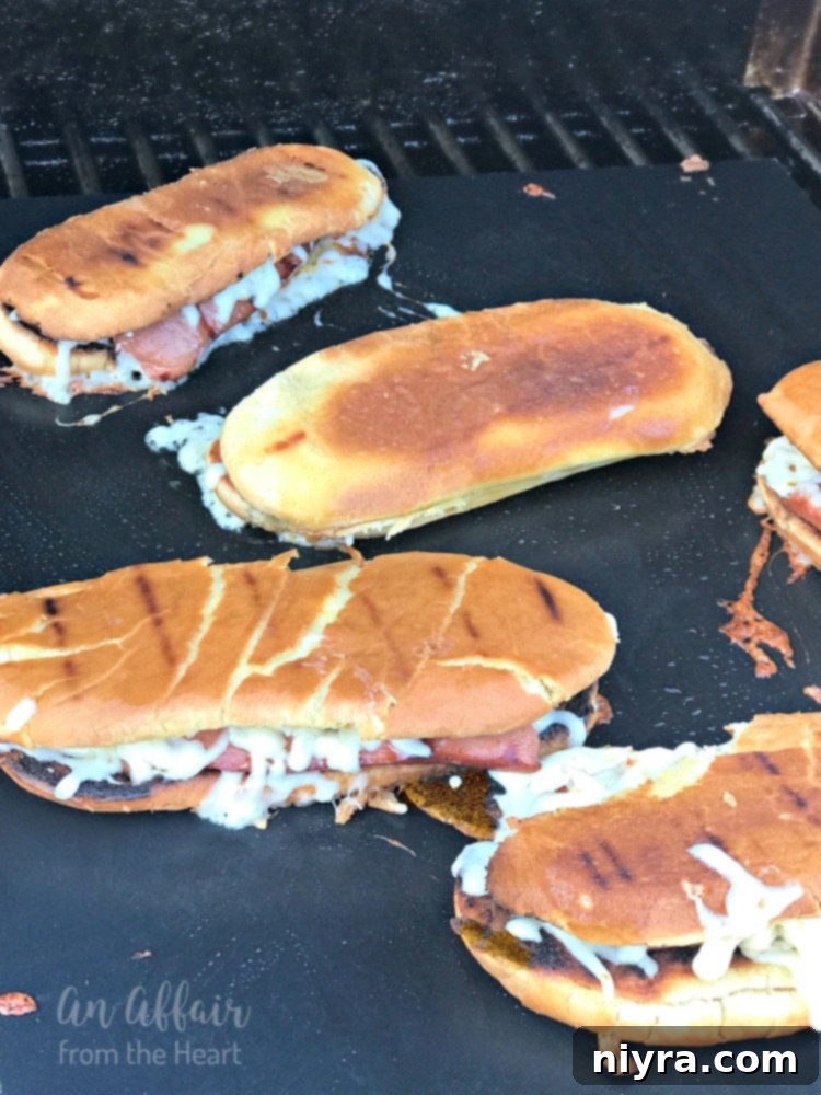 The top half of the bun being gently folded over the hot dog and melted pepper jack cheese, then pressed for the signature 'grilled cheese style' effect.