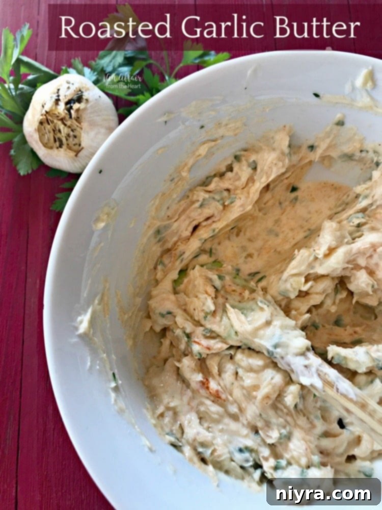 Glorious homemade roasted garlic butter, spread on a fresh baguette, garnished with herbs, ready to be enjoyed