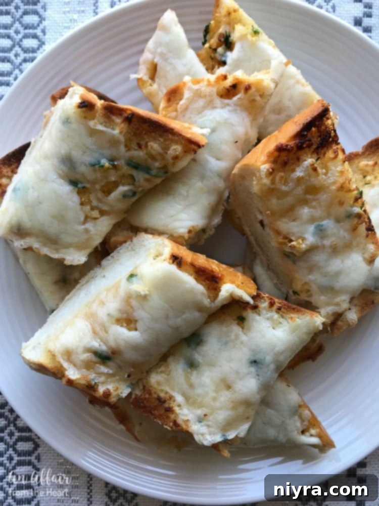 Delicious roasted garlic bread topped with melted mozzarella cheese, golden and bubbly from the oven