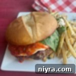 Italian Burger and french fries on a white plate
