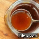 A full serving spoon of delicious honey bourbon sauce