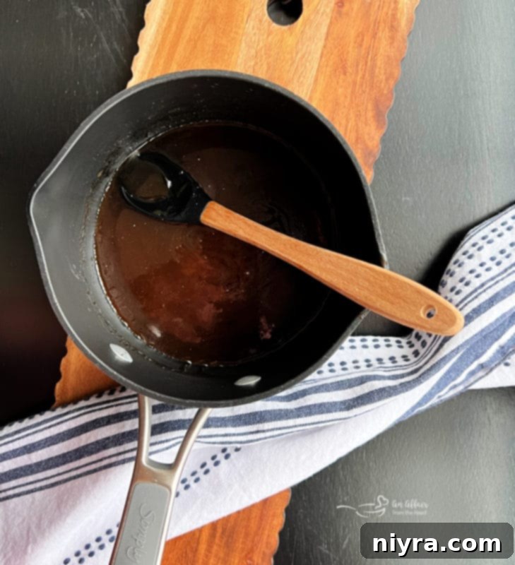 Adding bourbon to the melted butter and brown sugar