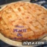 Whiskey-Spiked Peach Perfection 2 Close up shot of a slice of Whiskey Peach Pie