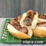 Kraut Stuffed Bacon Wrapped Brats on a festive plate