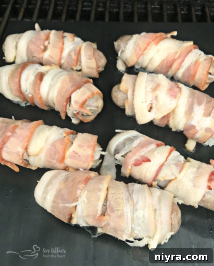 Kraut Stuffed Bacon Wrapped Brats, perfectly wrapped in bacon and ready for the grill mat