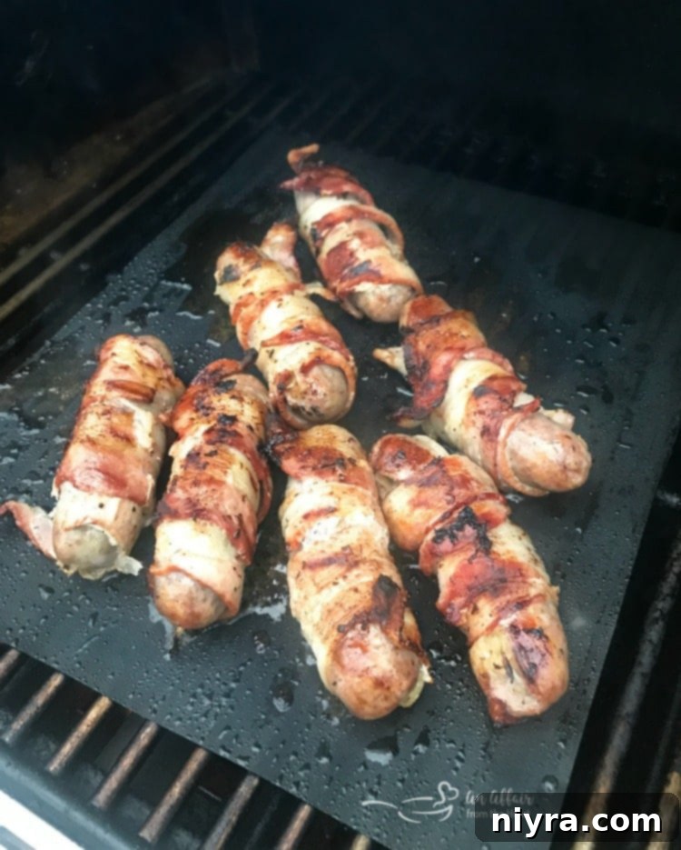Kraut Stuffed Bacon Wrapped Brats grilling to perfection